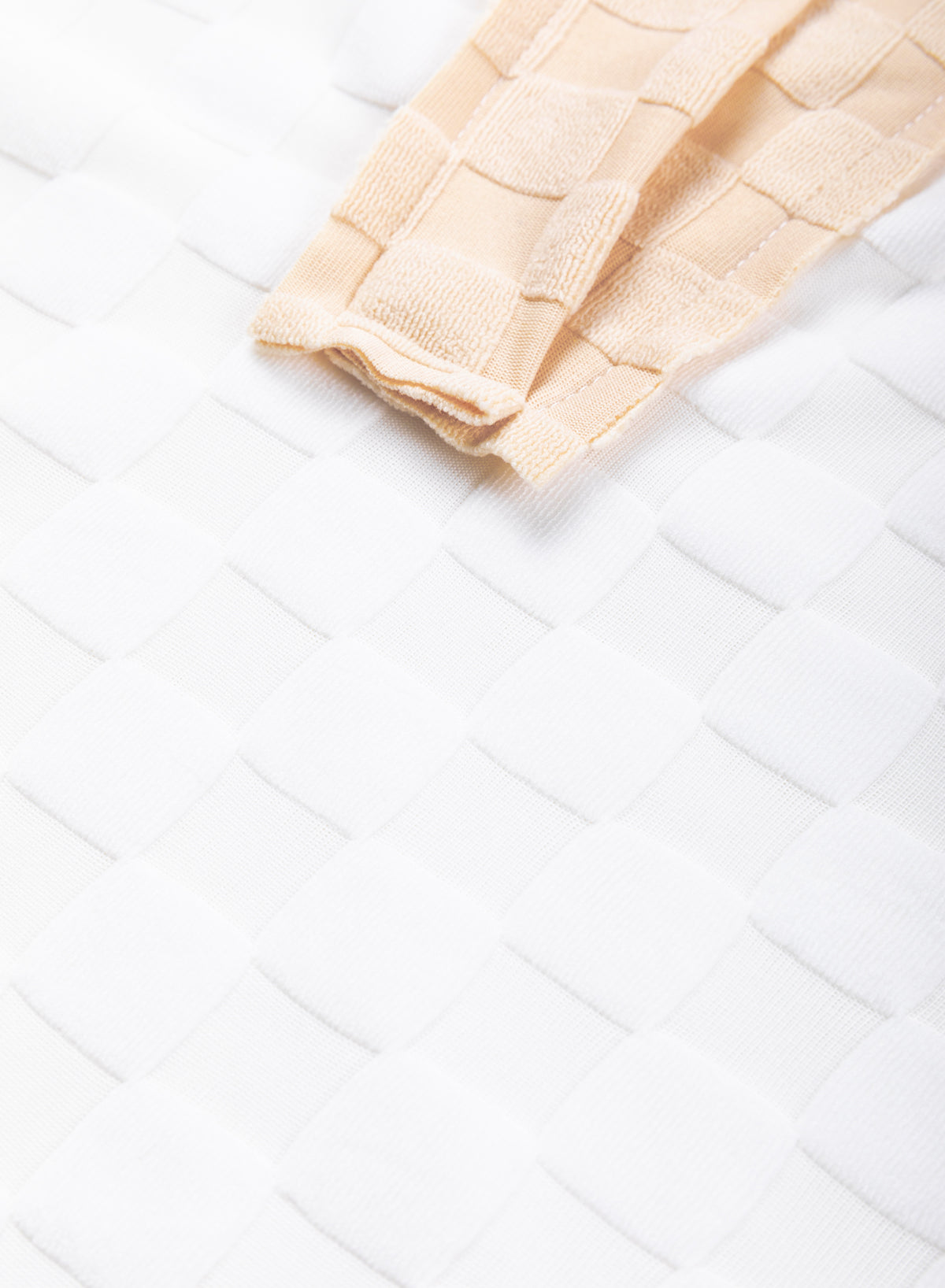 Loose-fitting white plaid top with exposed seams, V-neck