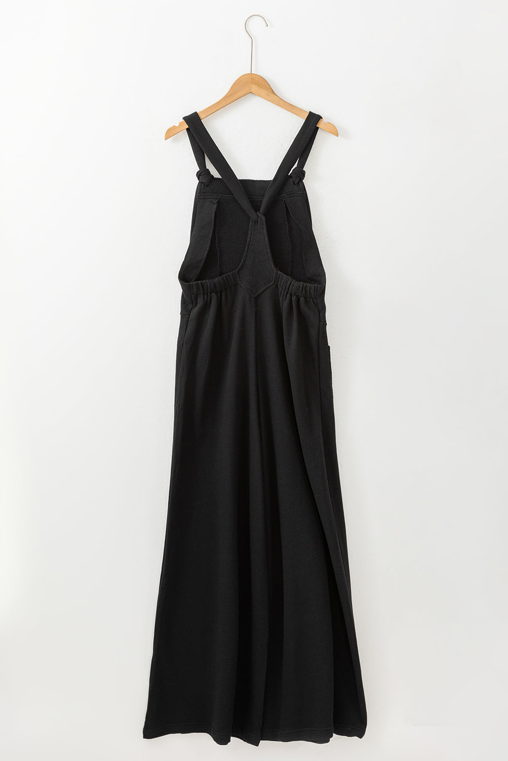 Black wide leg jumpsuit with knotted straps and patch pocket