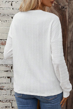 White textured knit top with crew neck and dropped shoulders