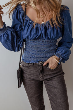 Smocked dark blue jeans blouse with ruffles and puffy sleeves in V -neck