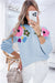 Light blue knitted sweater with ribbed edges with flowers pattern