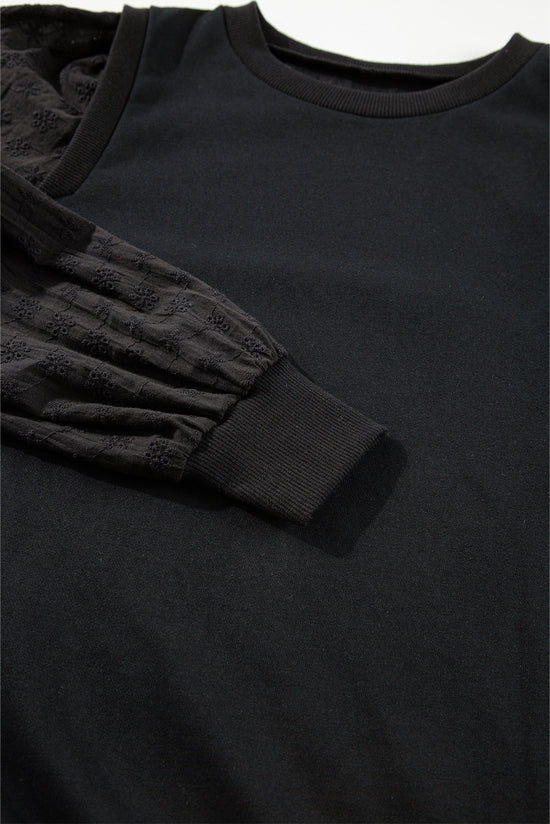 Plain black sweatshirt with patchwork sleeves and round neck