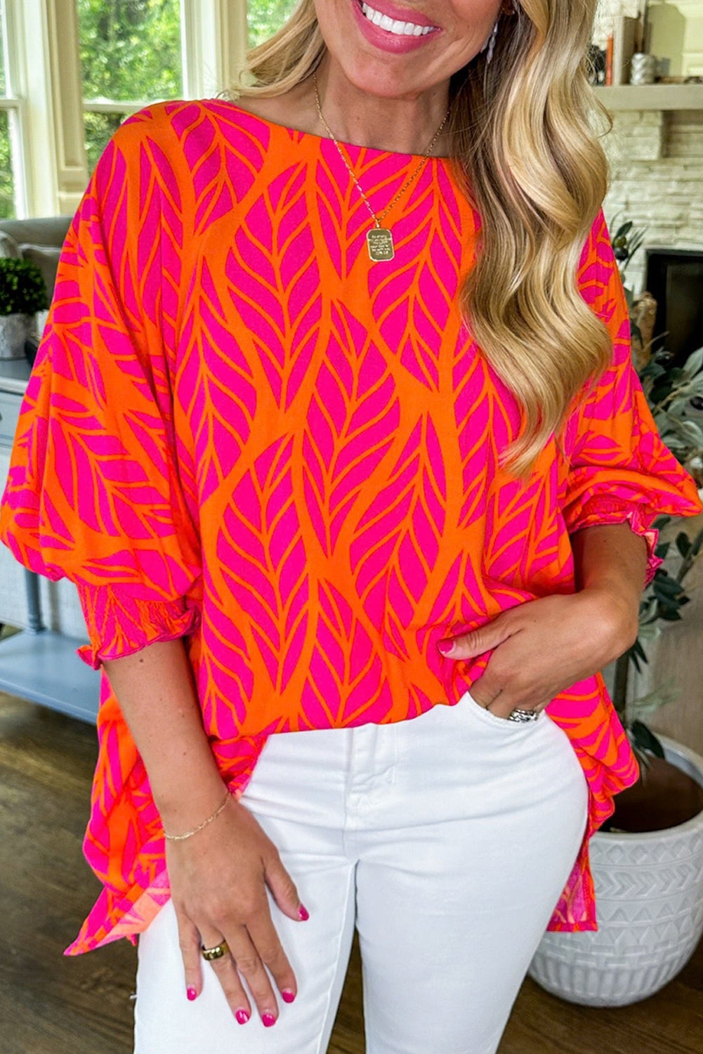 Smocked blouse with puffy sleeves and printed pink tropical leaves