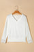 White high with long sleeves and V -neck with lace border and ribbed texture