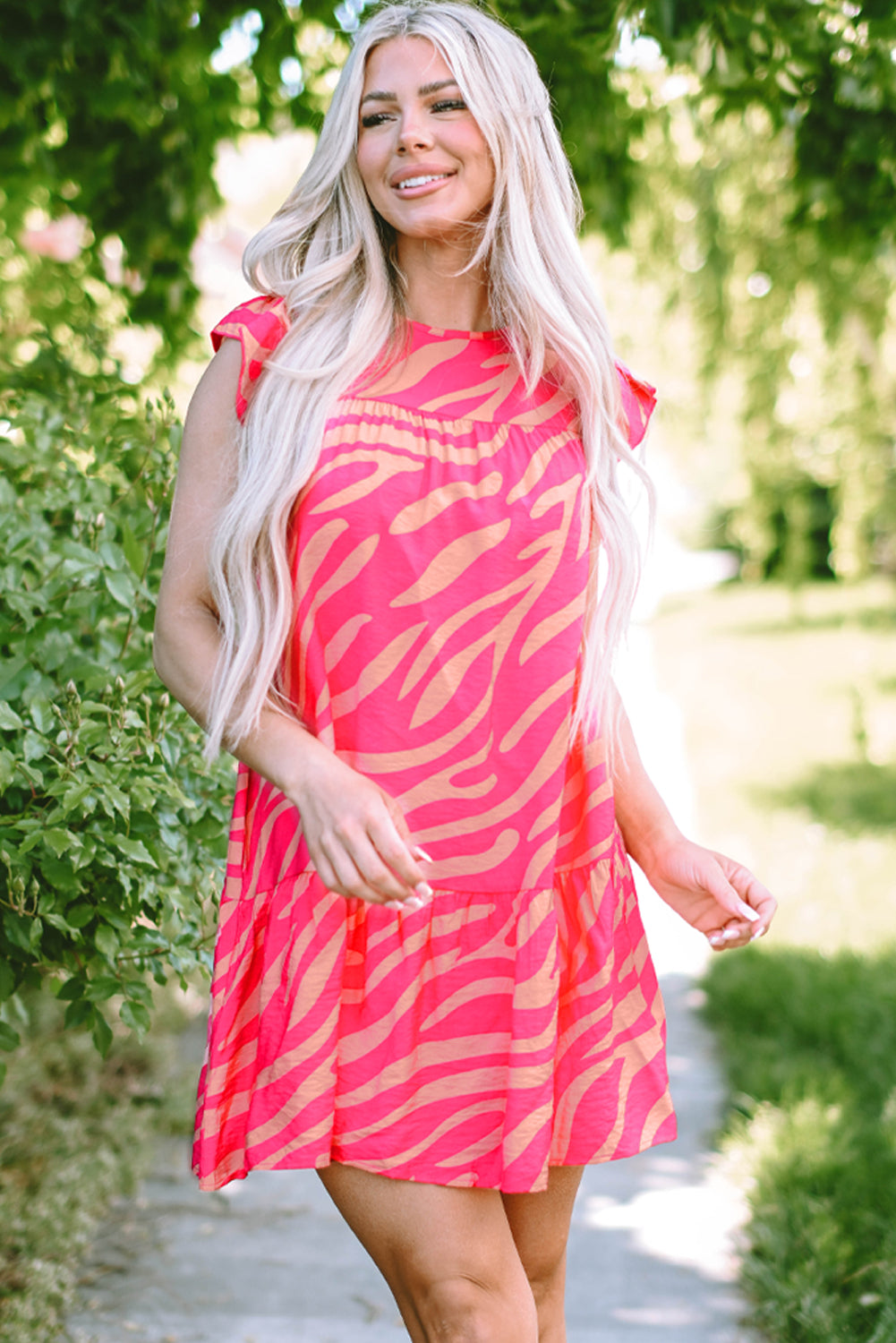 Pink dress with pockets and ruffle border printed with zero stripes