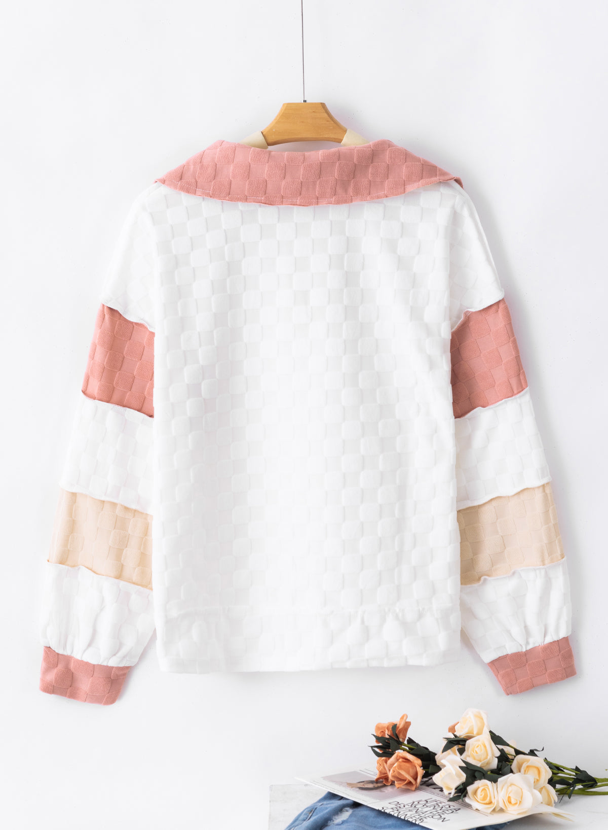 Loose-fitting white plaid top with exposed seams, V-neck