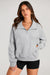 Light gray sweatshirt with stand-up collar and kangaroo pocket with quarter-turn zip