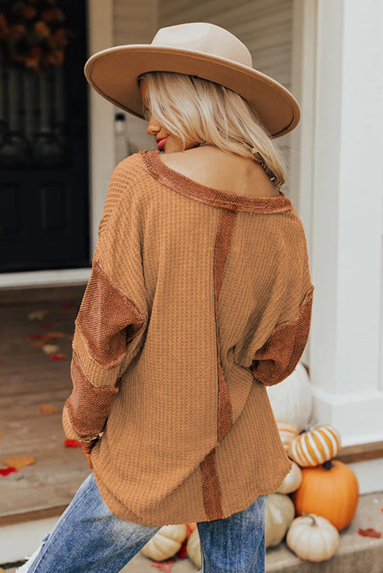 Waffle knit henley top with exposed seams and orange contrast patches