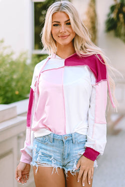 Pink hoodie with loose sleeves and exposed color block stitching