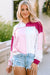 Pink hoodie with loose sleeves and exposed color block stitching