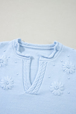 Knitted sweater with notched neck and flower details *