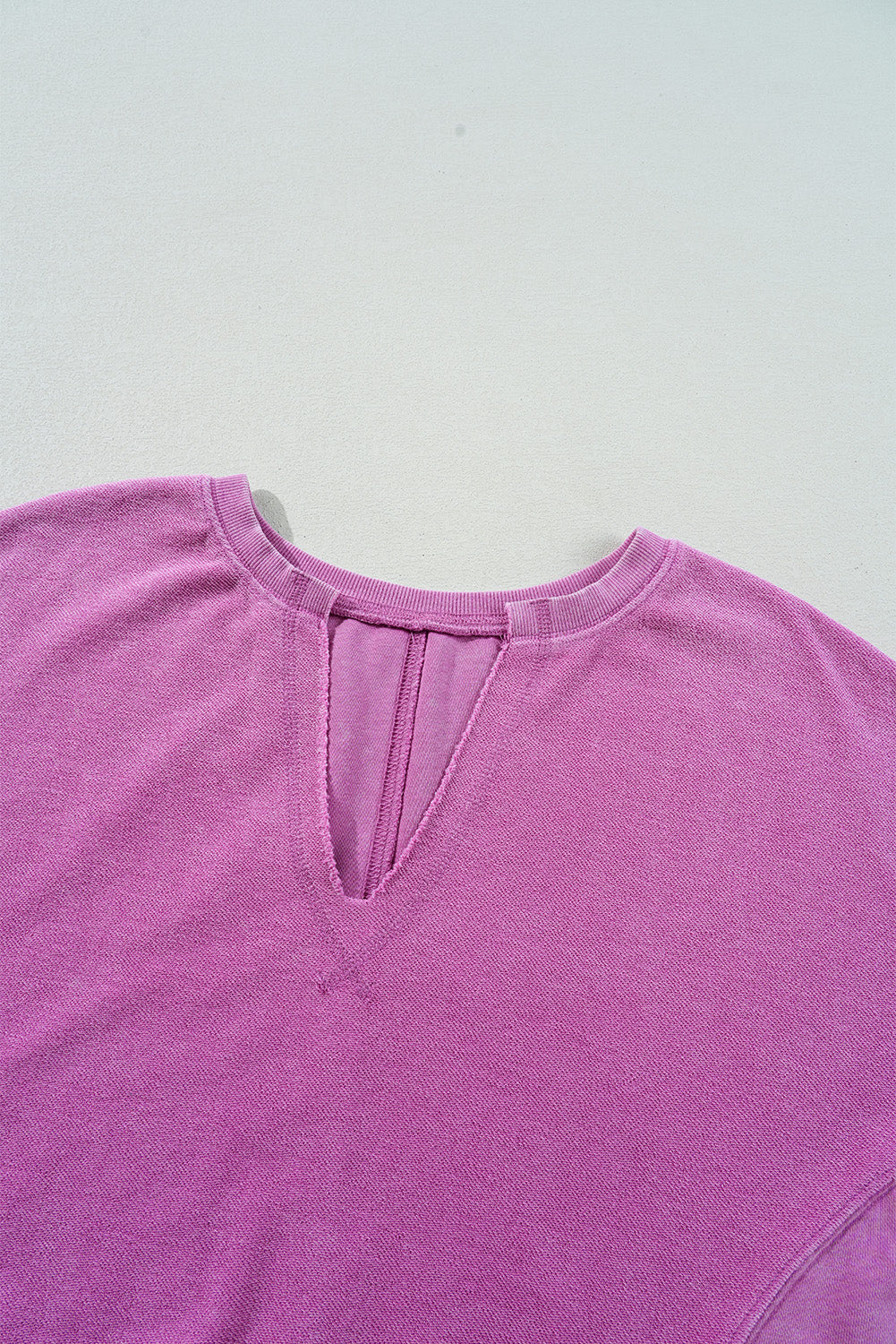 Hot pink sweatshirt with dropped shoulders and solid color notched collar