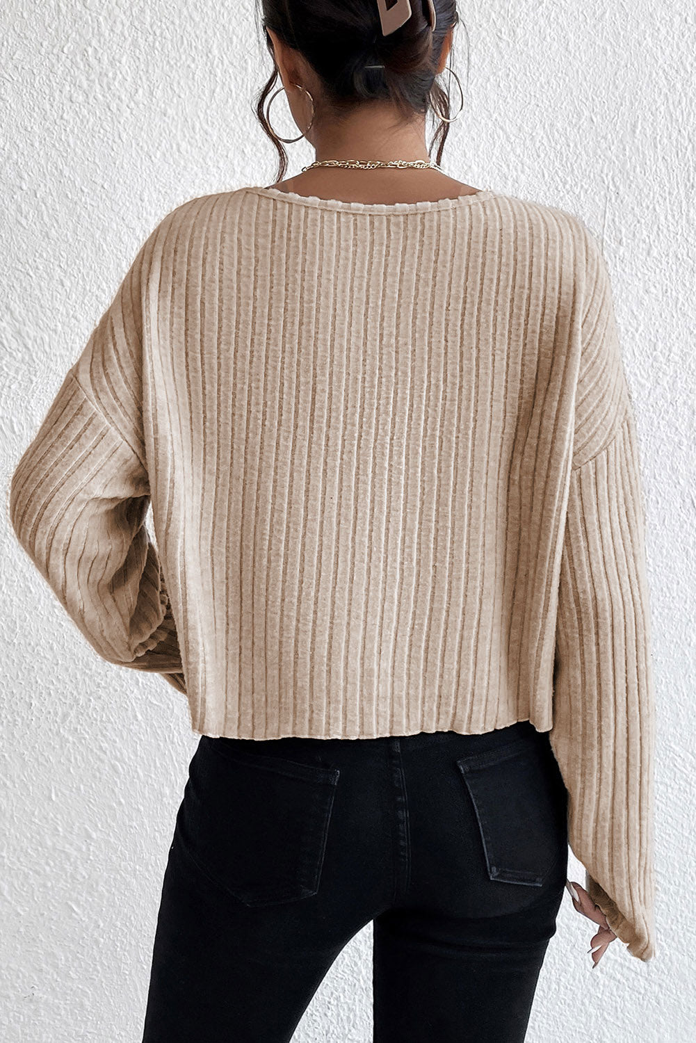 Loose ribbed knit top with dropped shoulders and cuffs in beige lettuce