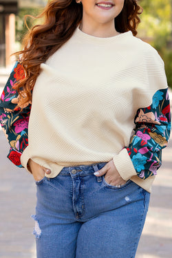 White textured sweater top with patchwork sleeves and large flowers