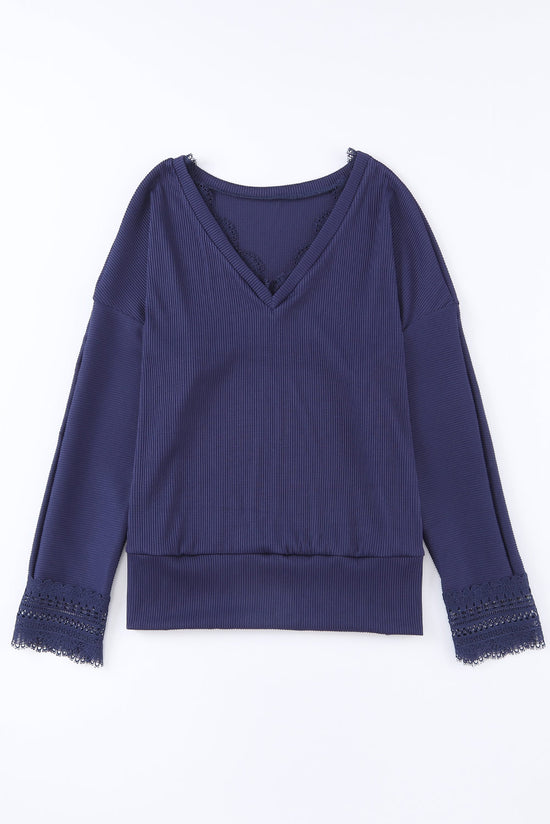 Blue long sleeve v-neck top with lace trim and ribbed texture