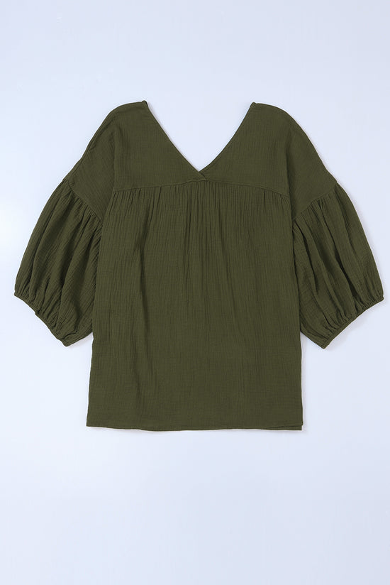 Textured green babydoll blouse in V -collar and bracelet sleeves