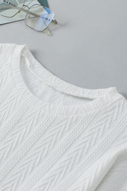 White textured knit top with crew neck and dropped shoulders