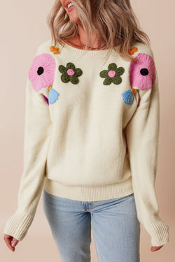 Beige knitted sweater with ribbed edges with flower pattern