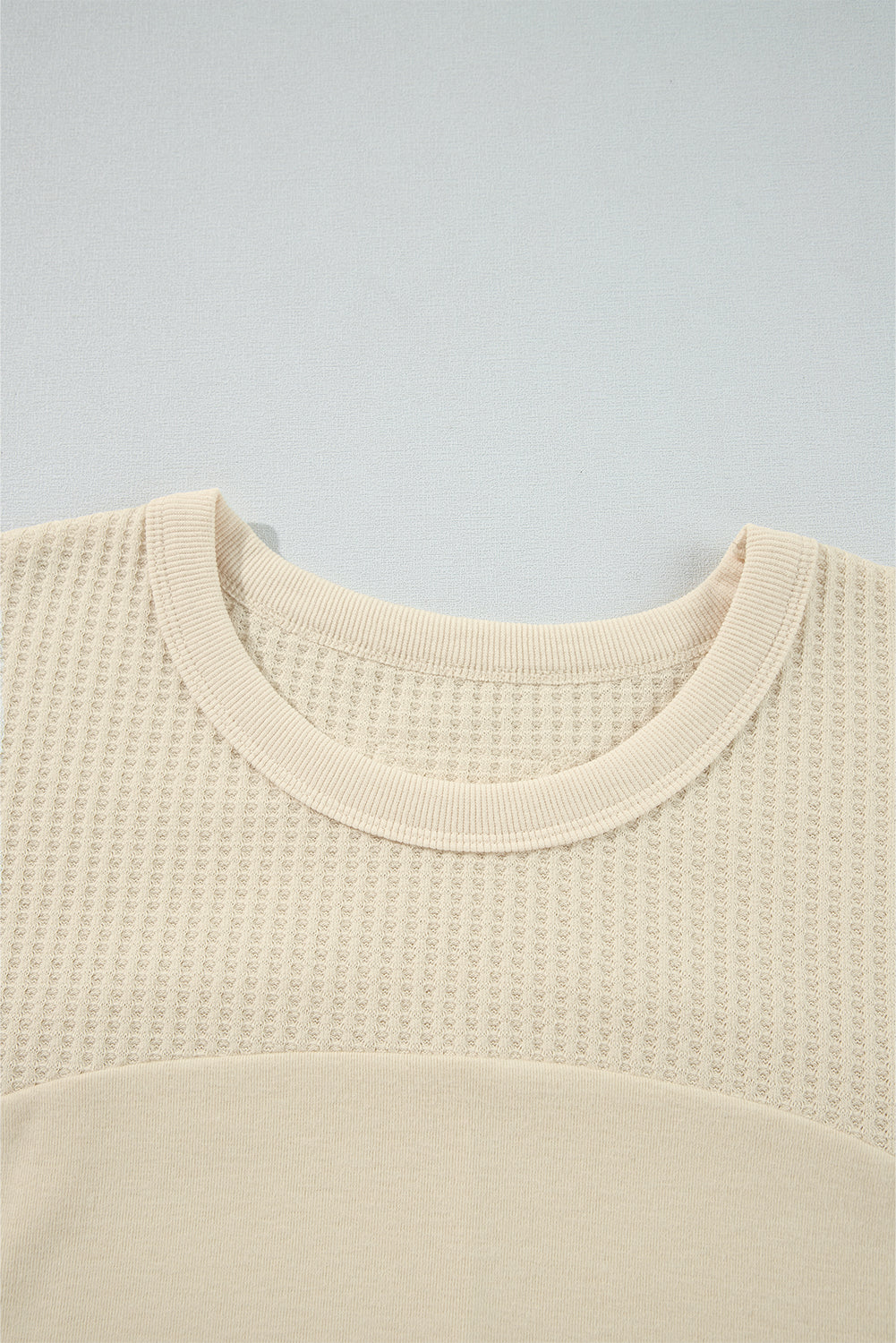 Beige long sleeve patchwork thermal knit top with exposed seams