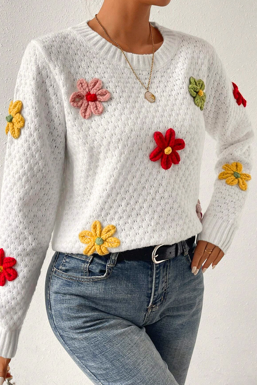 Textured knit sweater with white colorful flower appliques