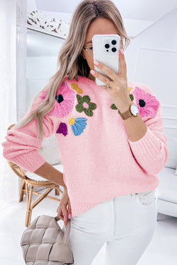 Pink knitted sweater with ribbed edges and flower pattern