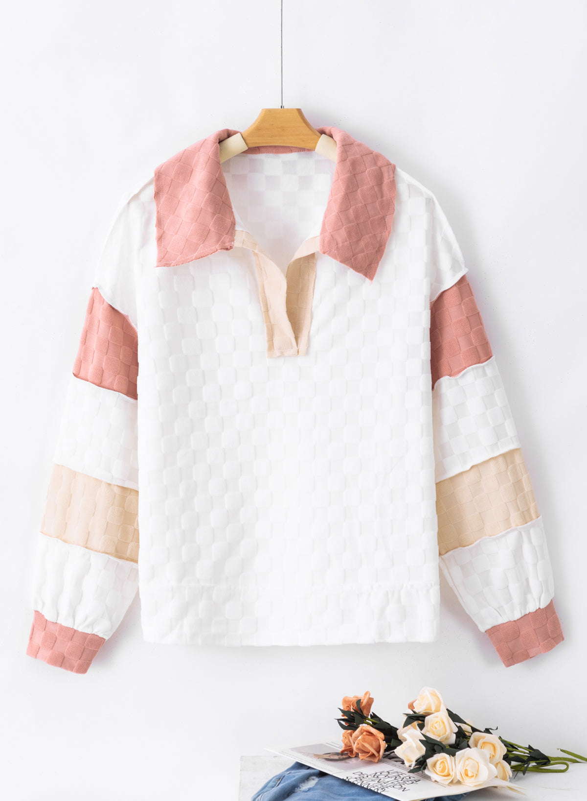 Loose-fitting white plaid top with exposed seams, V-neck