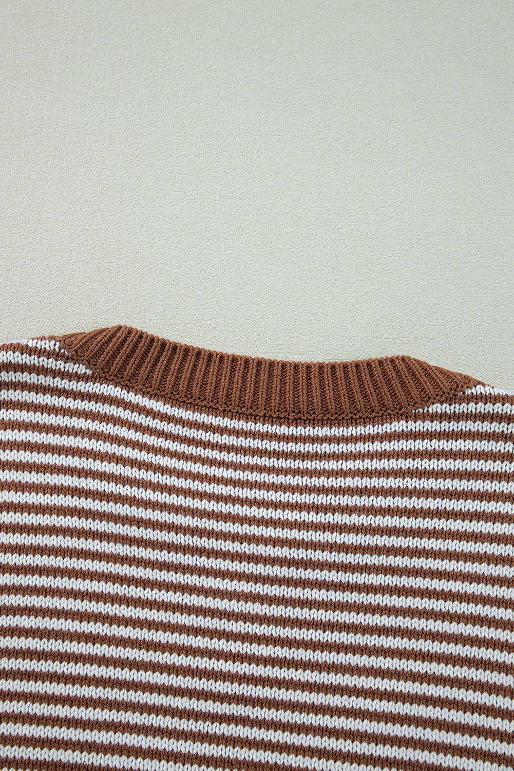 Brown sweater with textured geometric stripes and dropped shoulders