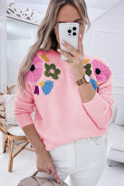 Pink knitted sweater with ribbed edges and flower pattern