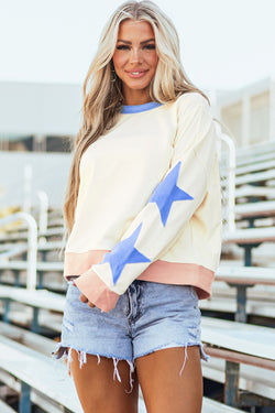 Beige oversized sweatshirt with patchwork stars and visible stitching