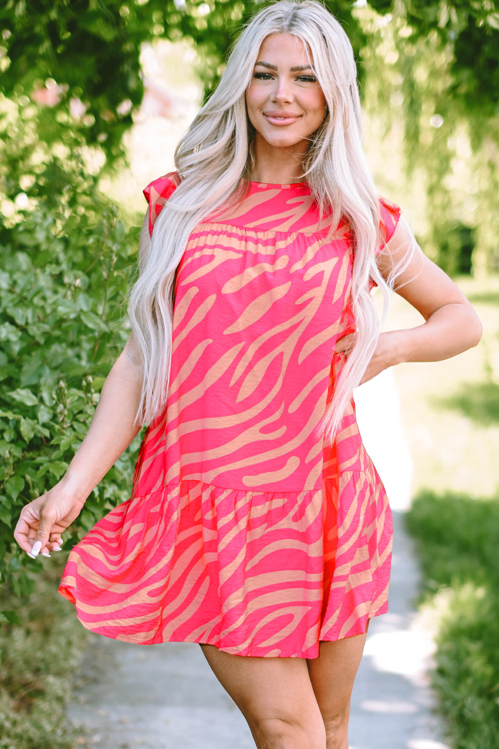Pink dress with pockets and ruffle border printed with zero stripes