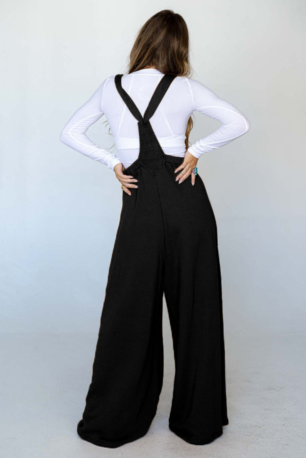 Black wide leg jumpsuit with knotted straps and patch pocket