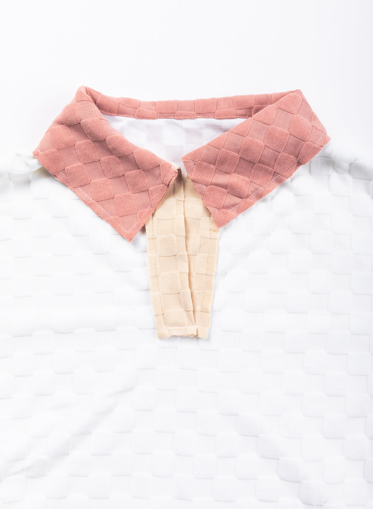 Loose-fitting white plaid top with exposed seams, V-neck