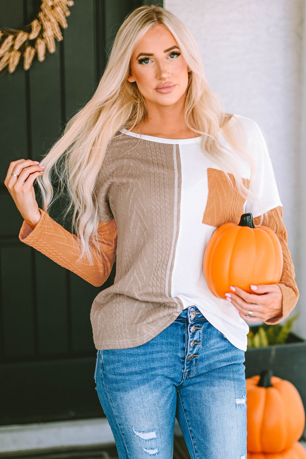 Orange textured knit top with long sleeves and color block chest pocket