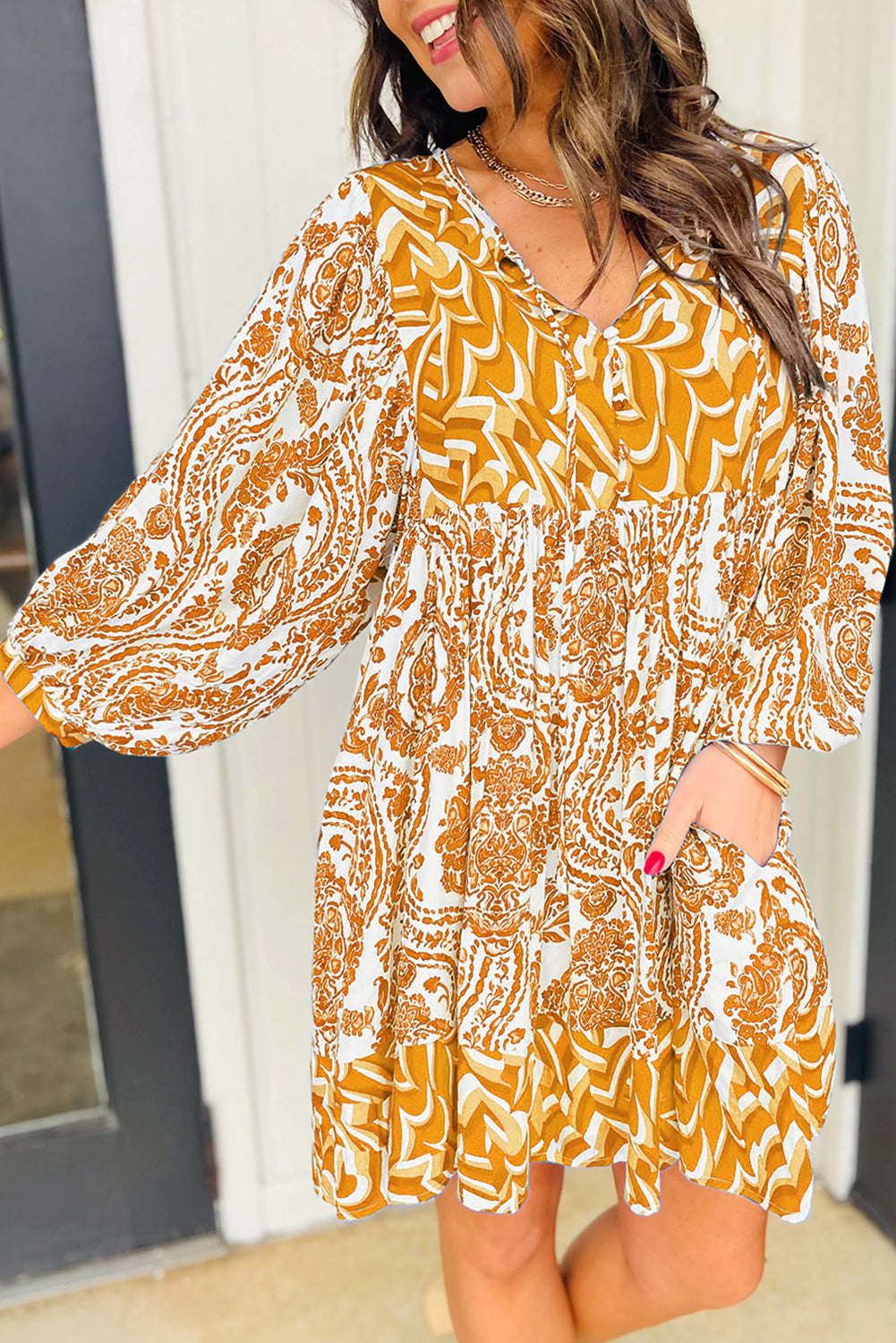 Orange bohemian print flared mini dress with puff sleeves and knotted V-neck