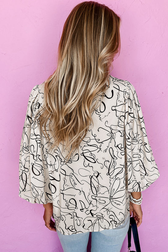 Blusa beige con cuello redondo y mangas de globo con estampado abstracto