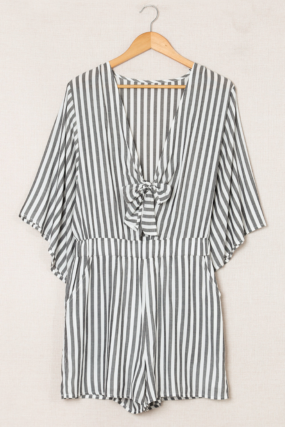 Grey striped romper with 3/4 wide sleeves and knotted front with pockets