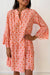 Orange floral print mini dress with ruffle sleeves and button front