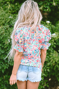 Pink blouse with floral print and buttoned, split collar, puffy sleeves