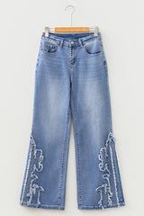 Jean évasé bleu à broderies et motifs western, longueur entière