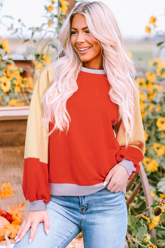 Orange raglan sleeve loose top with side slits and color blocking