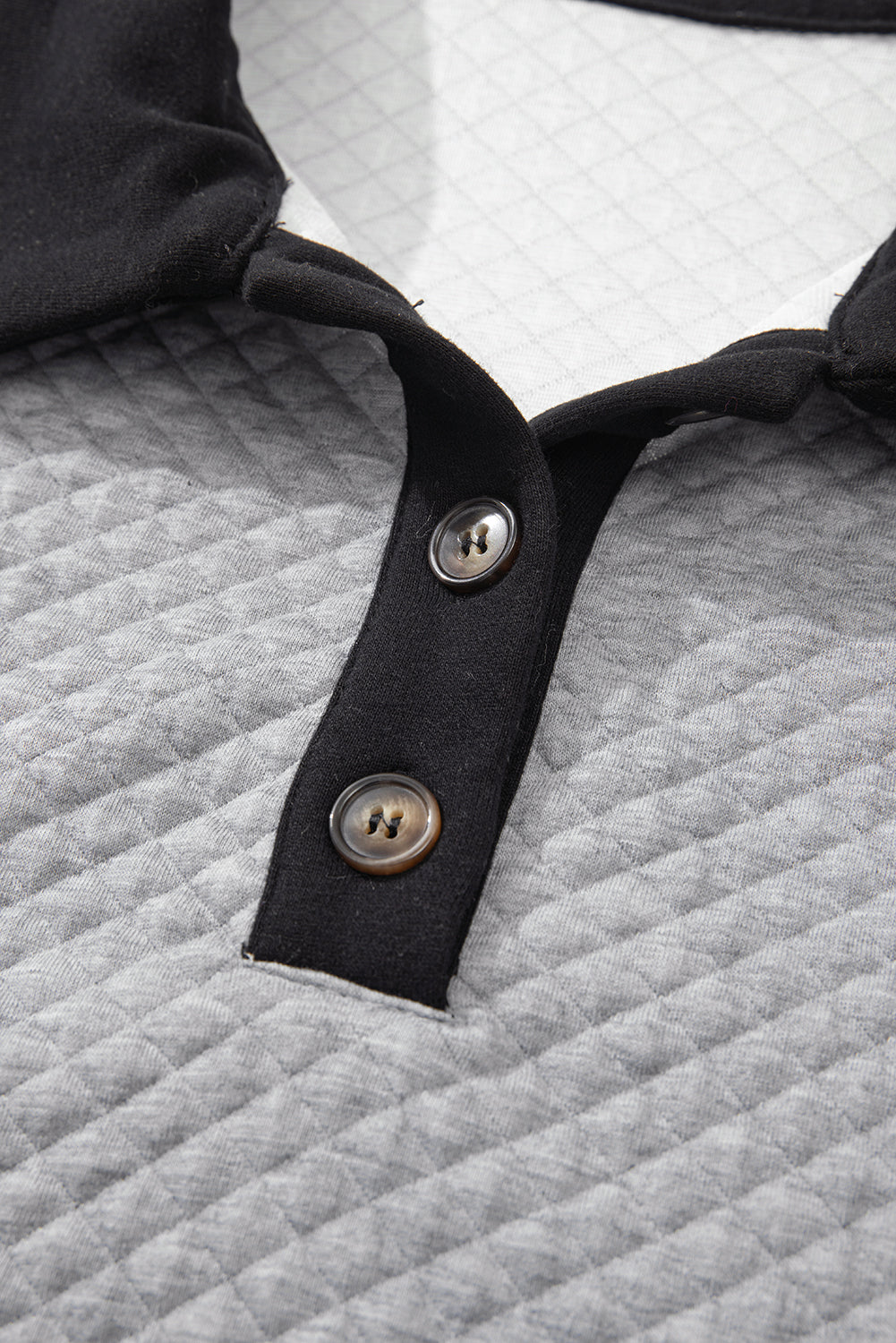 Sudadera gris texturizada gris claro en el bloque de color de los bordes y collar abotonado