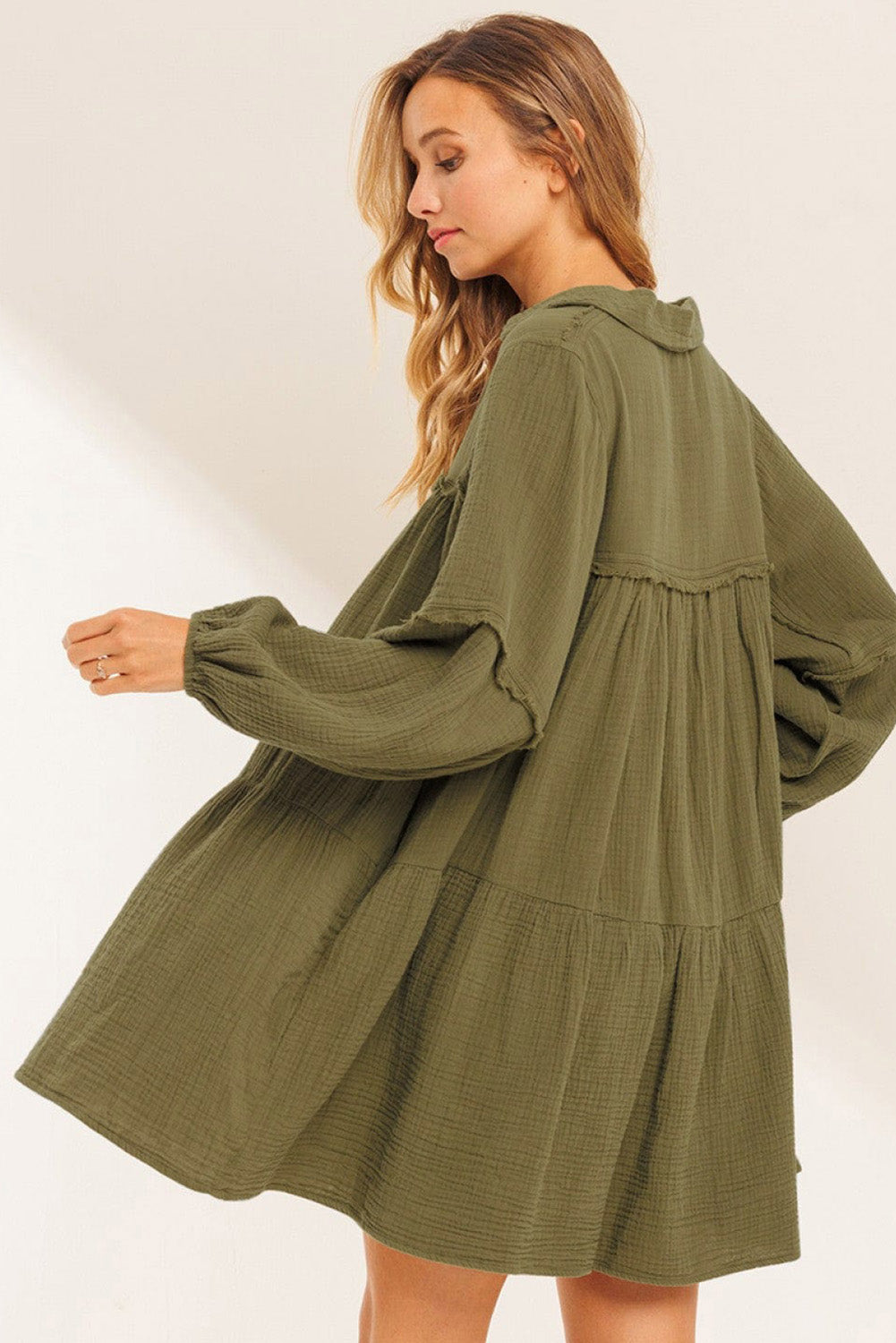 Green flared dress with frayed edging, split collar, puffed sleeves