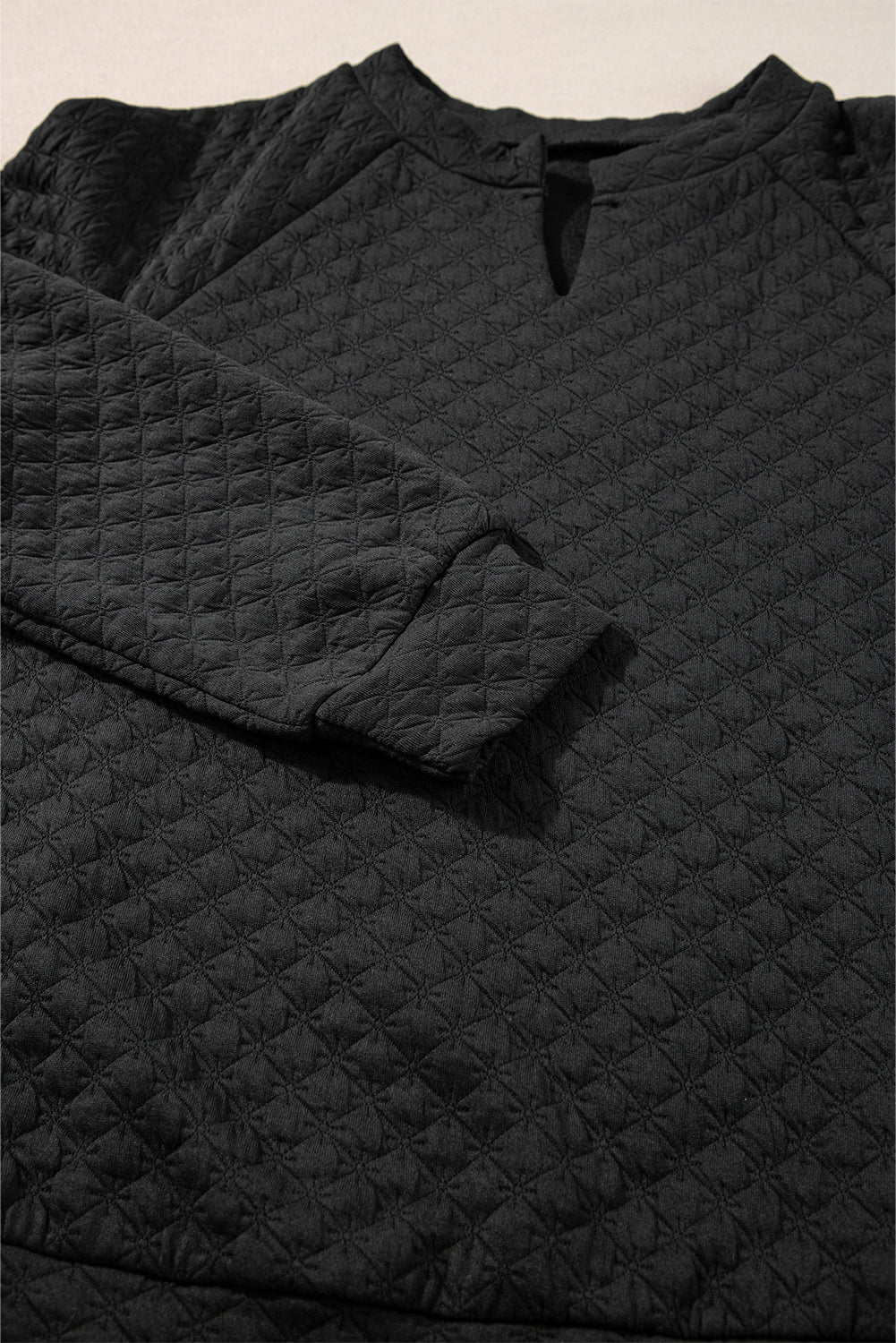 Black quilted top with long sleeves and split collar