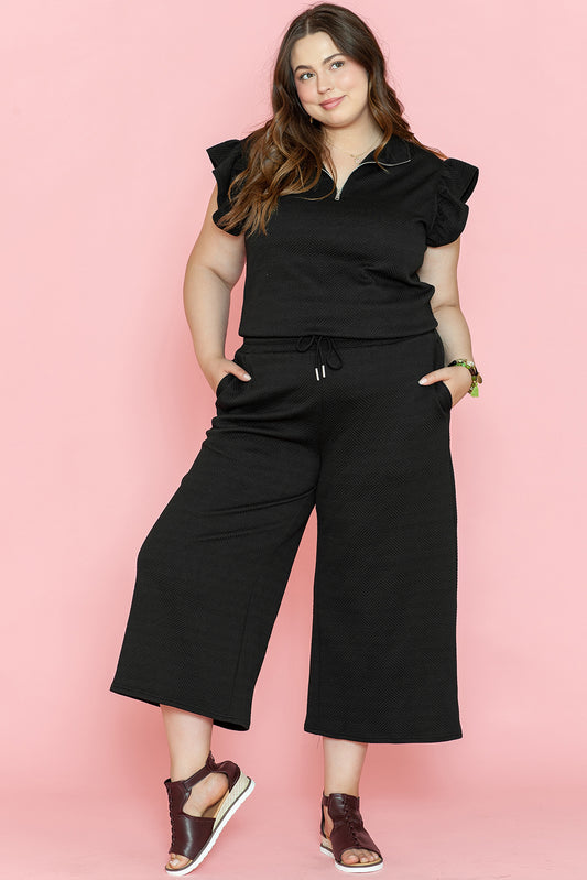 Ensemble pantalon large noir avec haut à manches volantées et quart de fermeture éclair