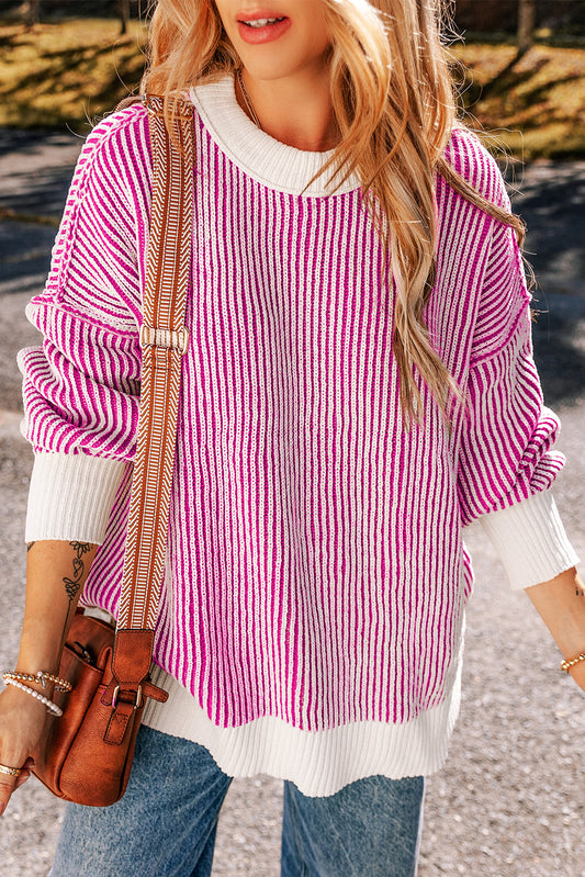 Loose-fitting sweater with contrasting edges in a textured knit with bright pink stripes