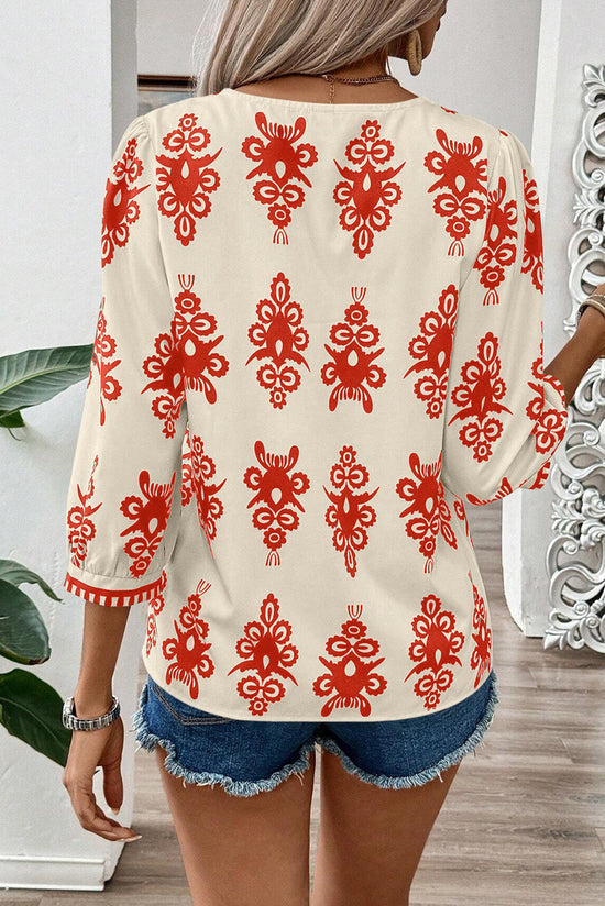 Blusa naranja con impresión geométrica*