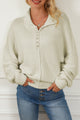 Beige sweater with dolman sleeves and buttoned stand-up collar with pearls