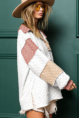 Loose-fitting white plaid top with exposed seams, V-neck