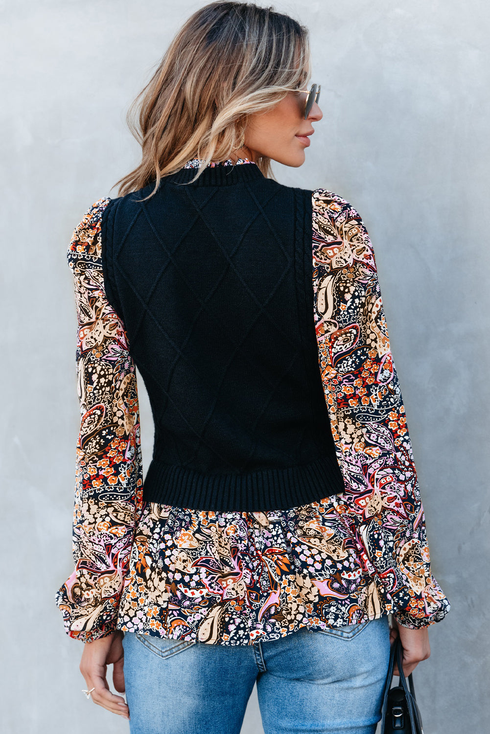 Black peplum sweater with contrasting floral sleeves