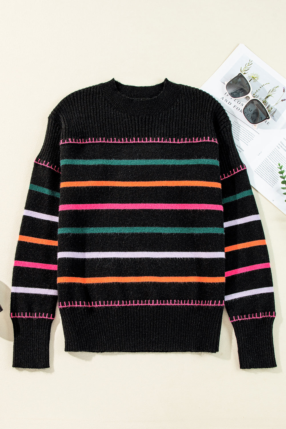 Black sweater with ribbed edges and colorful stripes